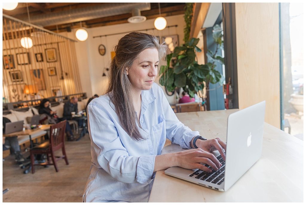 woman working on a computer in coffee shop