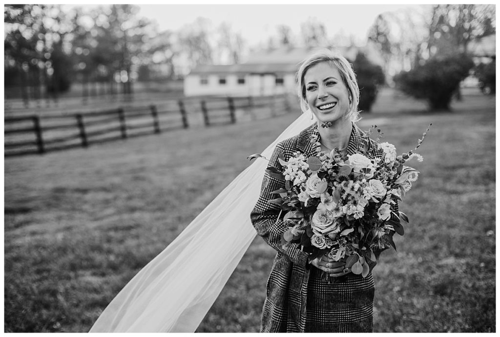 black and white bridal portrait with coat on